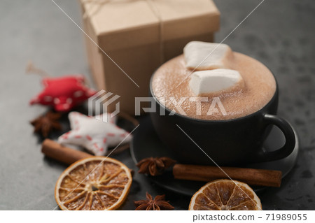 Hot chocolate in a black cup with christmas decorations 71989055