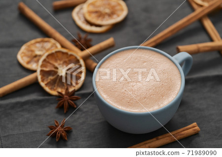 Hot chocolate in a blue cup with natural christmas decorations 71989090