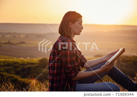 beautiful woman writing into her diary, in the park beautiful woman writing into her diary, in the park 71989344