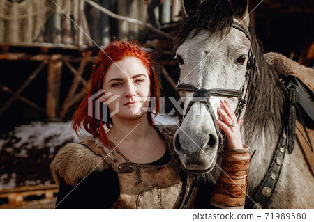 Viking girl. Reconstruction of a medieval scene Viking girl. Reconstruction of a medieval scene 71989380