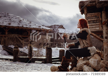 Viking girl. Reconstruction of a medieval scene Viking girl. Reconstruction of a medieval scene 71989389