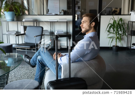 Capable millennial male expert travelling on business waiting for meeting 71989428