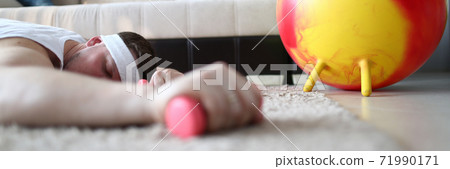 Close up of tired man that lying on the floor Close up of tired man that lying on the floor 71990171