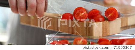 Close up of male hand that adding tomatoes into salad Close up of male hand that adding tomatoes into salad 71990307