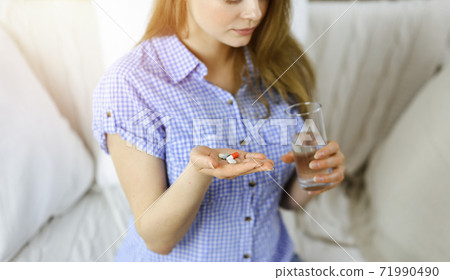 Beautician doing beauty procedure with syringe to face of young brunette woman in sunny spa center. Cosmetic medicine and surgery, beauty injections 71990490