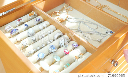 A jewelry box with a lot of jewelry 71990965