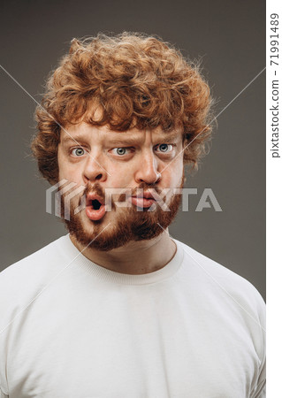 Young man with dual emotions combination on face isolated on dark background, emotional and expressive Young man with dual emotions combination on face isolated on dark background, emotional and expressive 71991489