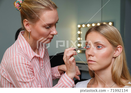 The process of creating makeup. Makeup artist 71992134