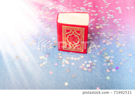 Islamic Holy Book Quran in mini size decorated with stars Islamic Holy Book Quran in mini size decorated with stars 71992531