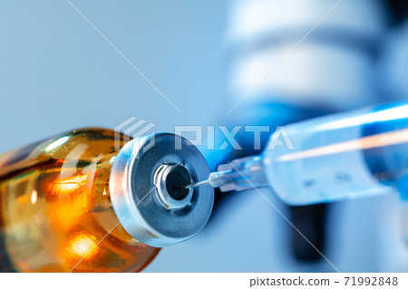Vaccine bottle with a syringe taking the vaccine from it Vaccine bottle with a syringe taking the vaccine from it 71992848