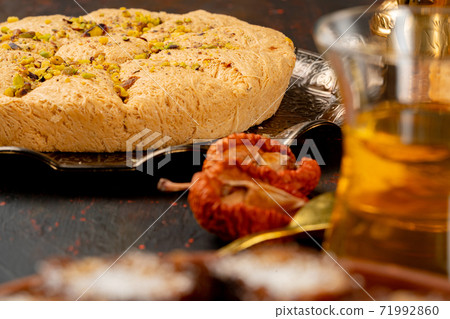 Glass cup of tes and turkish desserts on table Glass cup of tes and turkish desserts on table 71992860