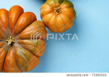 Small pumpkins on blue pastel background top view Small pumpkins on blue pastel background top view 71992910