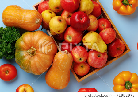 Pumpkins, apples and bell pepper composition on blue background 71992973