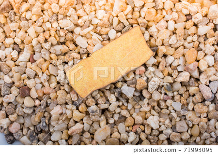 Grungy burnt paper with space for text on pebbles Grungy burnt paper with space for text on pebbles 71993095
