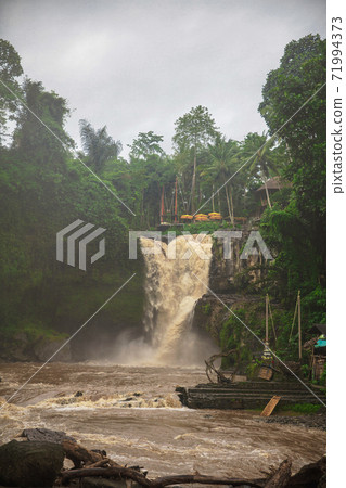 Muddy waters of a Tegenungan waterfall 71994373