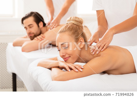Couples Massage, Relaxed Spouses Enjoying Procedure Lying At Spa Couples Massage, Relaxed Spouses Enjoying Procedure Lying At Spa 71994826