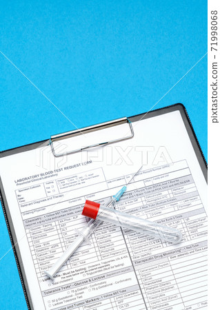 Clipboard with paper blank form with blood test tubes on blue background 71998068
