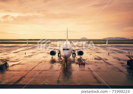 Airplane at airport during golden hour 71998228
