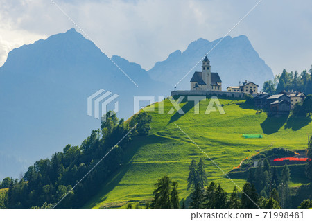 Mountainous landscape with villages of Colle Santa Lucia with church in Dolomites, South Tyrol, Italy Mountainous landscape with villages of Colle Santa Lucia with church in Dolomites, South Tyrol, Italy 71998481