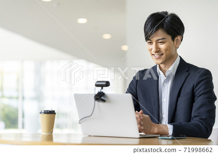 Image of businessman video call online conference talking to webcam Image of businessman video call online conference talking to webcam 71998662