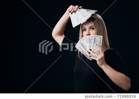 Stunning woman holding money cash Stunning woman holding money cash 71998839