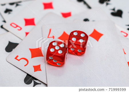 The dice are laid on top of the cards with a winning combination The dice are laid on top of the cards with a winning combination 71999399
