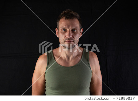 Very well built sexy male model in fashionable active sportwear against black background with copy space 71999837