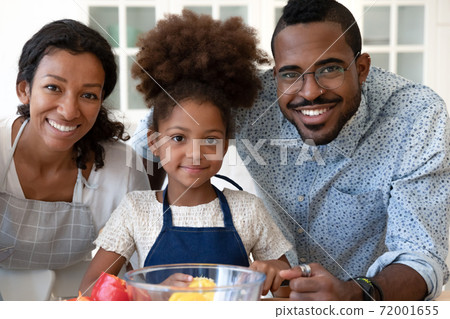 Portrait of happy black family of three at modern kitchen Portrait of happy black family of three at modern kitchen 72001655