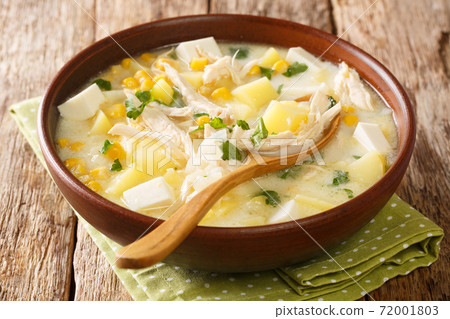 Delicious Venezuelan soup made from chicken, corn, cheese, vegetables and cream close-up in a bowl. horizontal 72001803