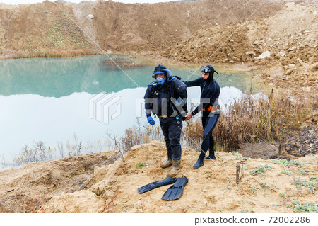 Lifeguard in a wetsuit to work underwater. Search at the bottom of the pond. 72002286