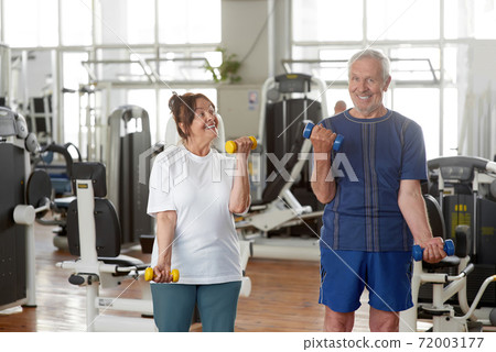 Senior caucasian couple exercising using dumbbells. Senior caucasian couple exercising using dumbbells. 72003177