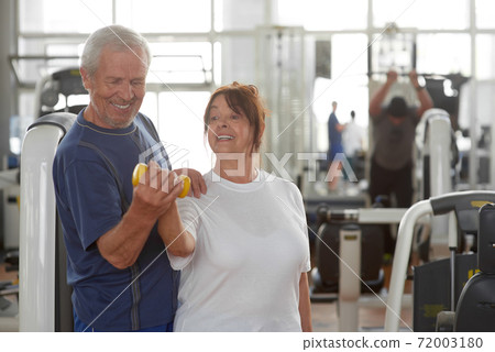 Cheerful elderly couple working out. Cheerful elderly couple working out. 72003180