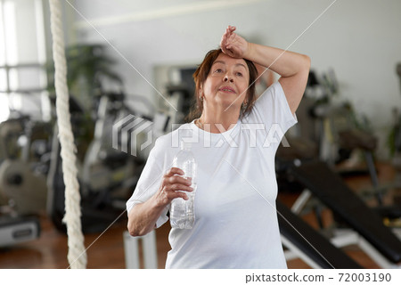 Tired senior woman after gym workout. Tired senior woman after gym workout. 72003190