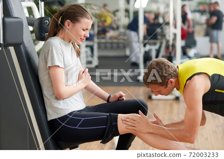 Unhappy young woman with injured knee at gym. Unhappy young woman with injured knee at gym. 72003233