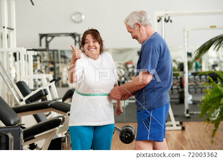 Mature woman happy with her diet results. Mature woman happy with her diet results. 72003362