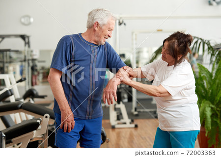 Senior man feeling pain in elbow during workout. 72003363