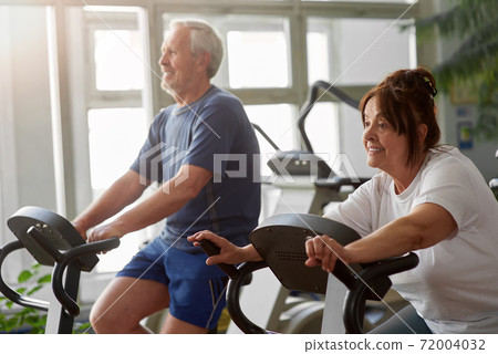 Elderly woman working out in modern gym. Elderly woman working out in modern gym. 72004032
