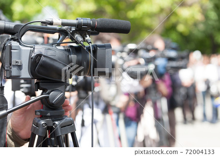 News conference. Filming media event with a video camera. 72004133