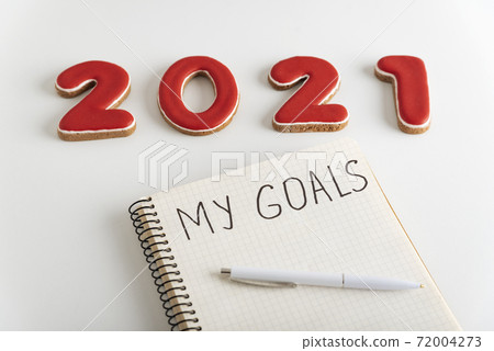 Notebook with inscription My goals, pen and numbers 2021 on white background. Close up 72004273