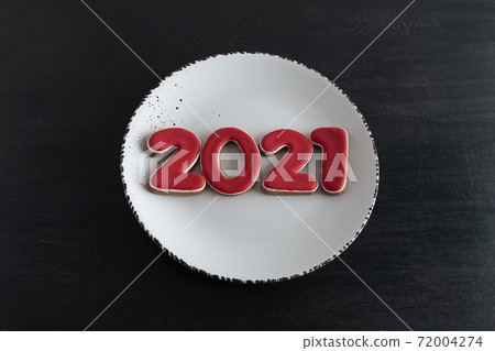 Numbers 2021 from gingerbread 2021 on white plate, top view. New year concept 72004274