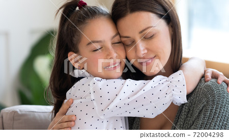 Happy young mother and small daughter hug showing love 72004298