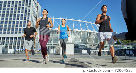 Young caucasian athletes running during training 72004553
