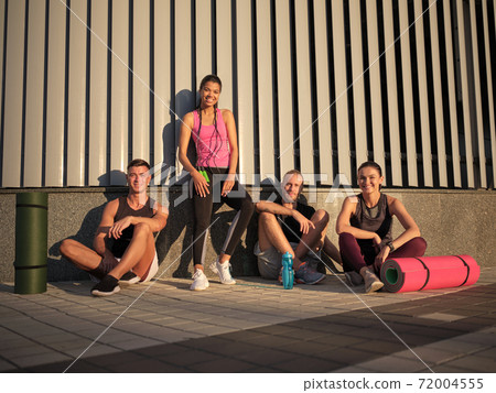 Smiling young multiracial sportive people after workout Smiling young multiracial sportive people after workout 72004555