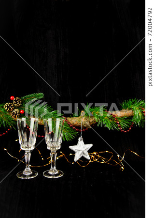 New Years concept, lights, Christmas tree, New Year decorations, two champagne glasses. Festive mood, place for an inscription. 72004792