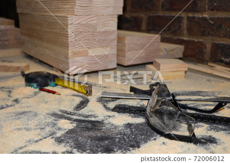 Safety Glasses And Equipment On Dusty Carpentry Bench Safety Glasses And Equipment On Dusty Carpentry Bench 72006012