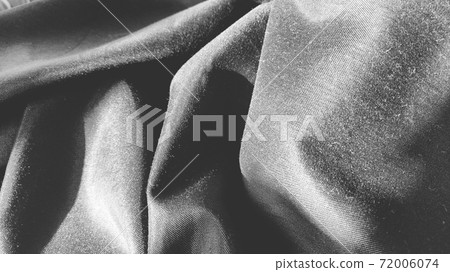 black fabric with interlacing threads close-up. Black and white monochrome photography. Nice beautiful waves on the material. Folded fabric. Interior decoration, sewing clothes and curtains. black fabric with interlacing threads close-up. Black and white monochrome photography. Nice beautiful waves on the material. Folded fabric. Interior decoration, sewing clothes and curtains. 72006074