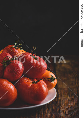 Fresh red and yellow tomatoes on plate Fresh red and yellow tomatoes on plate 72006359