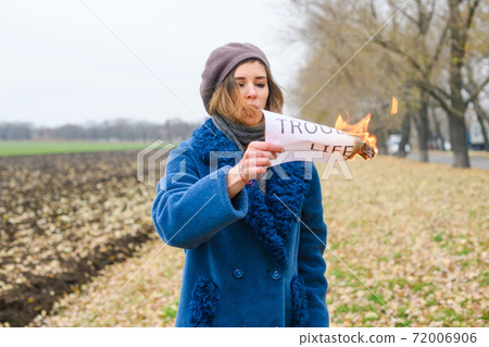 Girl burn paper with Trouble life text 72006906