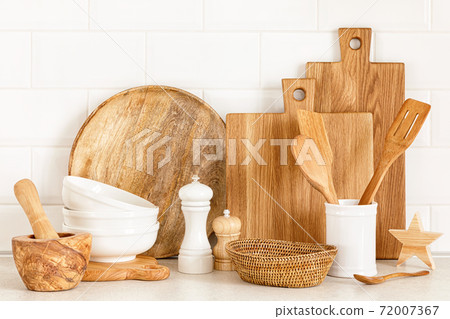 Kitchen utensils on countertop, culinary background, wooden and white ceramic kitchenware, home cooking concept Kitchen utensils on countertop, culinary background, wooden and white ceramic kitchenware, home cooking concept 72007367