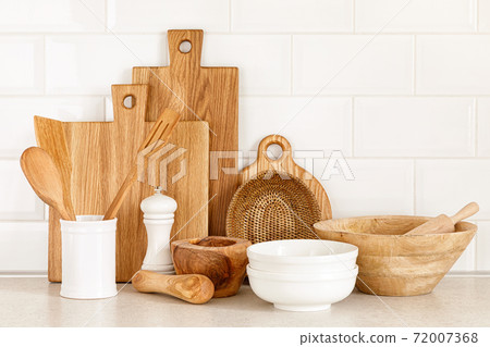 Kitchen utensils on countertop, culinary background, wooden and white ceramic kitchenware, home cooking concept Kitchen utensils on countertop, culinary background, wooden and white ceramic kitchenware, home cooking concept 72007368